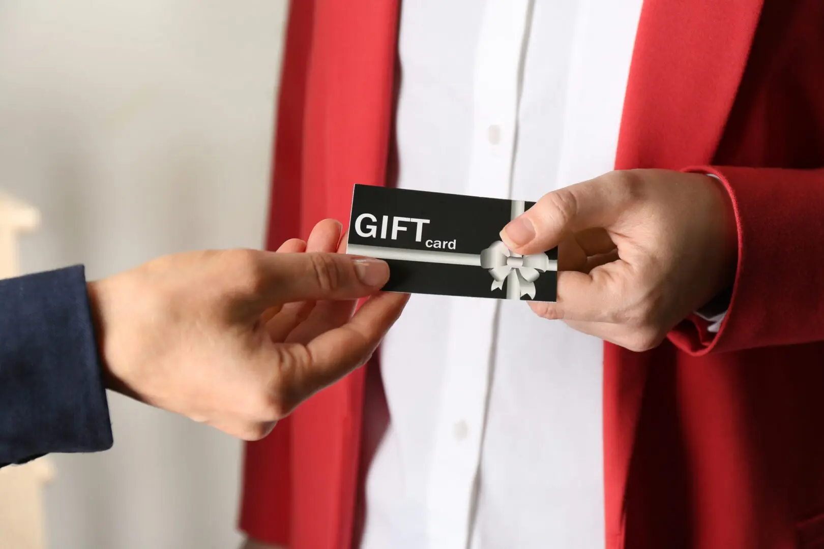 Hands exchanging a gift card