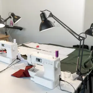 Sewing workspace with lamps and machines