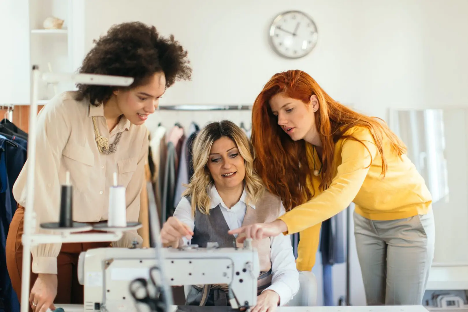Women collaborating at a sewing machine