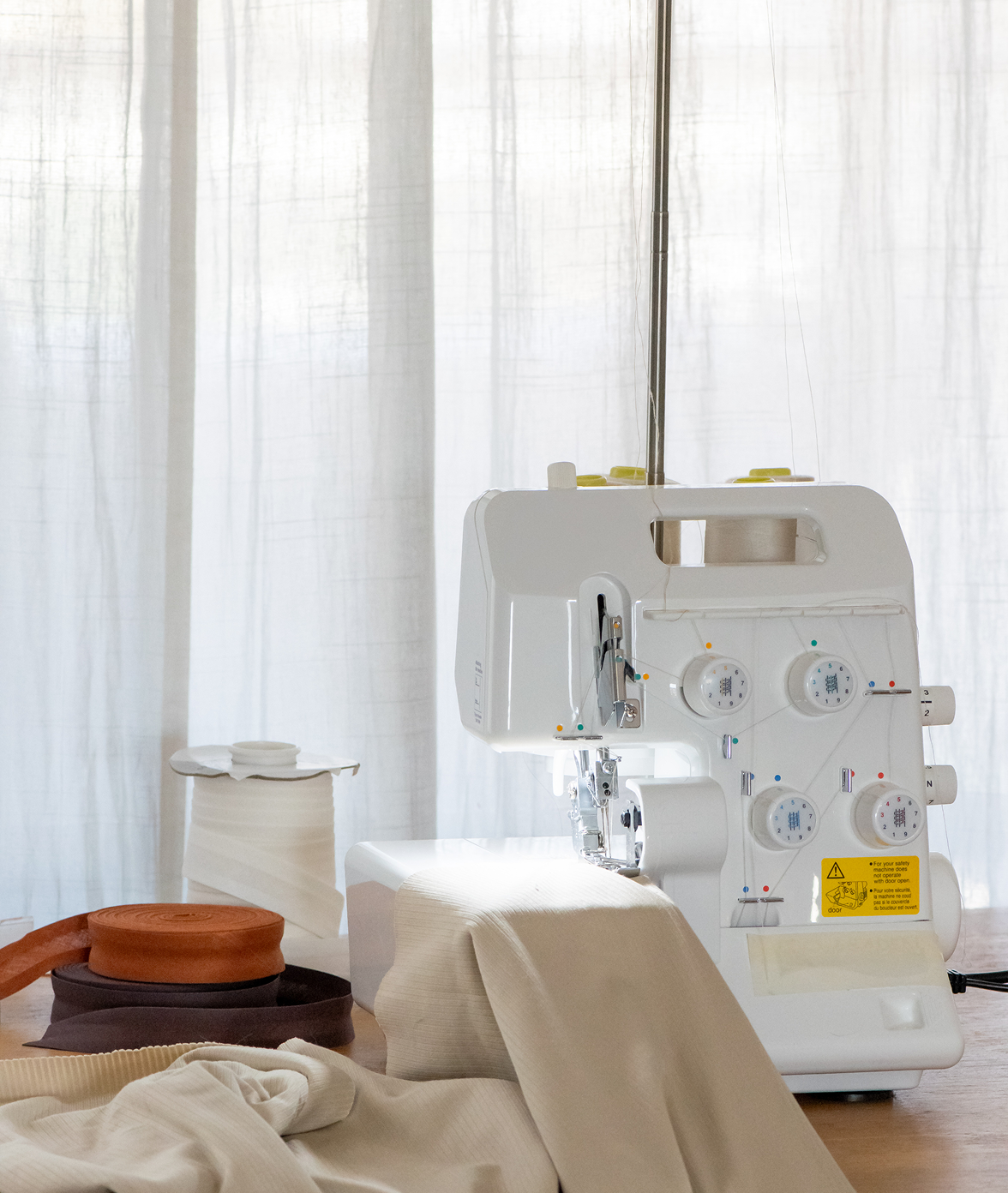 Sewing setup with white curtains