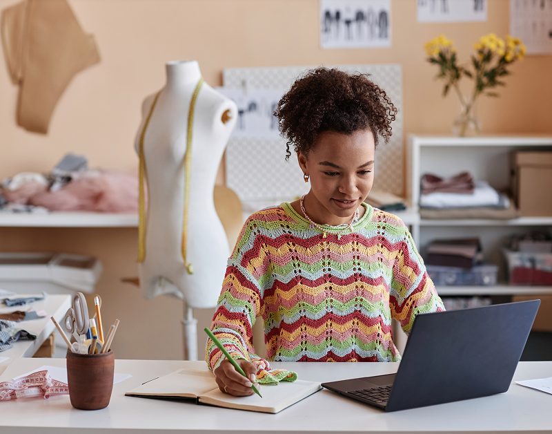 Fashion designer working on laptop