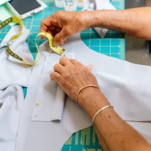Tailor adjusting garment piece